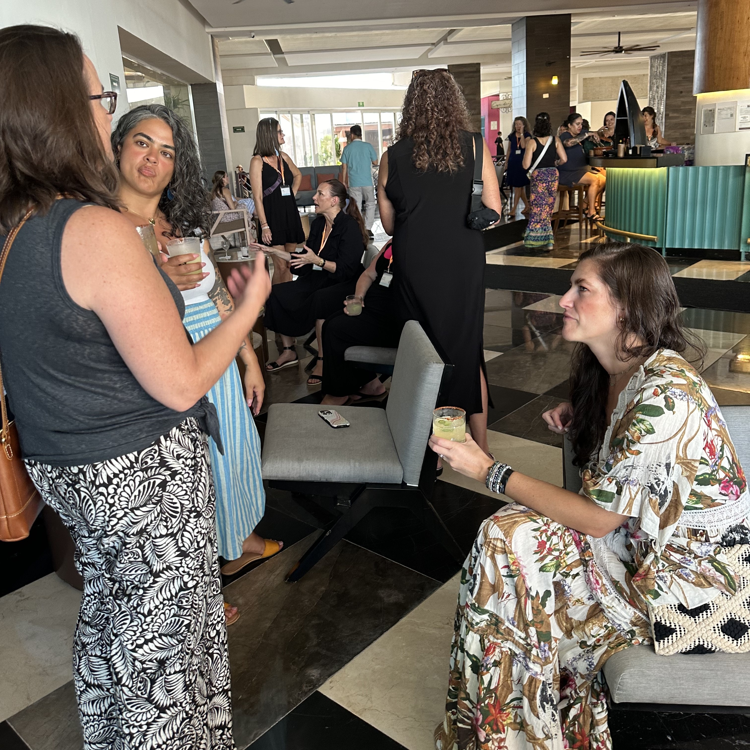 Attendees socializing at an indoor event